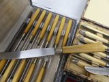 a box of knives and a knife sharper on a table