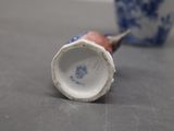 a small blue and white vase sitting on a table