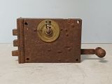 an old clock that is on a table with a key
