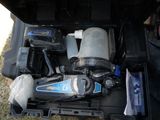 an open tool box with tools in it sitting on the grass