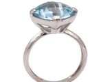 a close up of a ring with a blue topaz stone