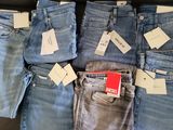a lot of jeans that are sitting on a table