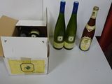 three bottles of wine sitting in a box on a table