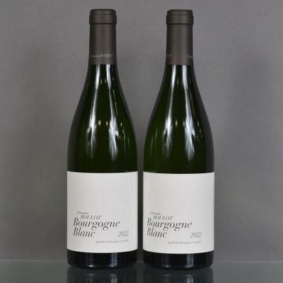two bottles of wine sitting on top of a table next to each other