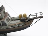 a model of a boat that is sitting on a white surface