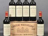 six bottles of red wine in a wooden crate on a table