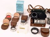 many different types of cameras and accessories on the table