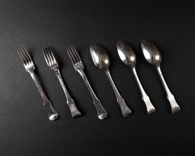 six forks and spoons are arranged in a row on a black surface