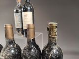 three bottles of wine sitting on a table next to each other