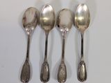 five spoons are lined up in a row on a white surface