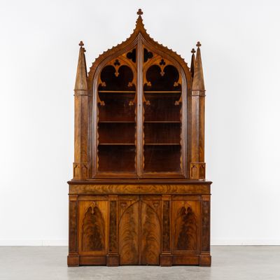 an old wooden bookcase with a glass door and a wooden shelf