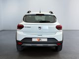 the rear end of a white car in a white room