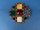 a close up of a cross made out of multi colored stones