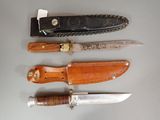 several different types of knives are lined up on a table