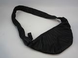 a black purse on a white table with a black strap