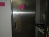 a stainless steel refrigerator in a kitchen with a pink sticker on the door
