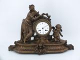 a bronze clock with a statue of a woman and a child
