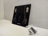a black electronic scale sitting on a white counter