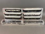 four train cars are stacked on top of each other on a table