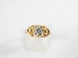an image of a gold ring with a grey diamond