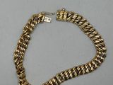 a gold chain bracelet with a diamond clasp