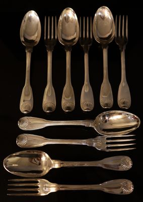 a lot of silver spoons and spoons on a table