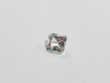 a close up of a square cut diamond on a white surface