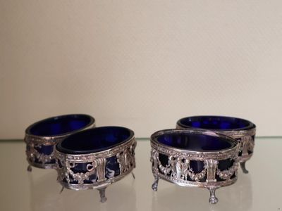 two blue glass bowls sitting on a glass table