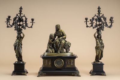 three bronze statues of a woman, a man and a child