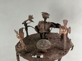 sculpture of a group of people sitting on top of a tree stump