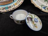 a cup and saucer sitting on a table next to a plate