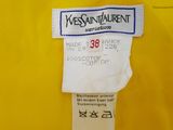 the label of a yellow dress with a blue and white design