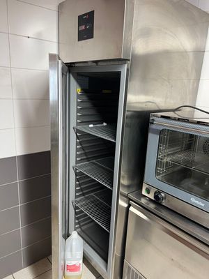 a large stainless steel oven and a toaster oven in a kitchen