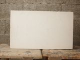 a white board sitting on top of a wooden table