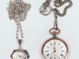 two different types of watches and a chain on a table