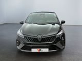 the front view of a grey car in a room with a white wall