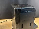 a black desktop computer sitting on top of a wooden table