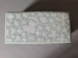 a picture of a green and white box with flowers on it