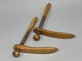two wooden baseball bats and a ball on a table