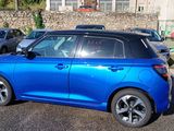 a blue car that is parked in a parking lot