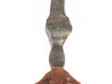 a small brown object hanging from a hook on a white background