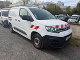 a white van with red and white stripes parked in a parking lot
