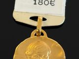 an image of a gold medal with a woman ' s face on it