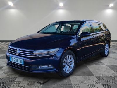 the blue volkswagen passat is parked on a checkered floor
