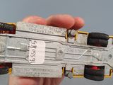 a person holding a toy car in their hand