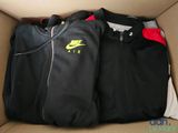 two jackets in a cardboard box with a zippered hoodie