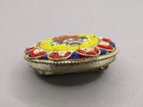 a close up of a silver box with a colorful design on it