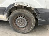 a white van that has a flat tire on the side of it