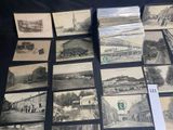 a lot of old black and white pictures on the table