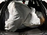 the back of a car with a bag of food in the trunk